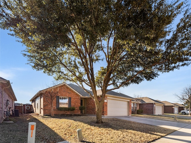 single story home with central AC unit and a garage