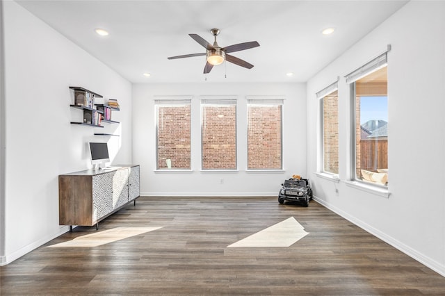 interior space with dark wood-type flooring and ceiling fan