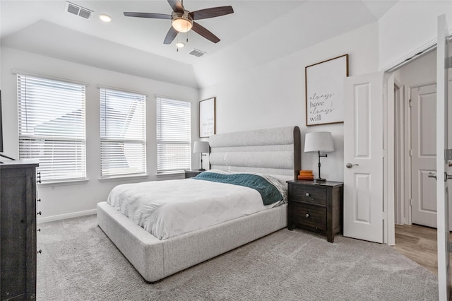 carpeted bedroom with multiple windows, vaulted ceiling, and ceiling fan