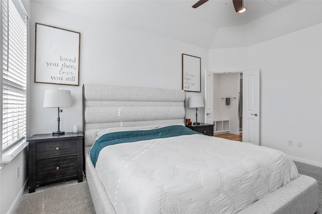 carpeted bedroom with ceiling fan and vaulted ceiling