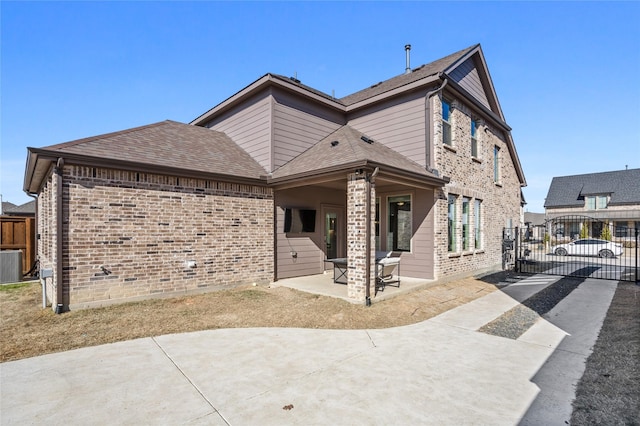 view of front of home with central AC unit and a patio area