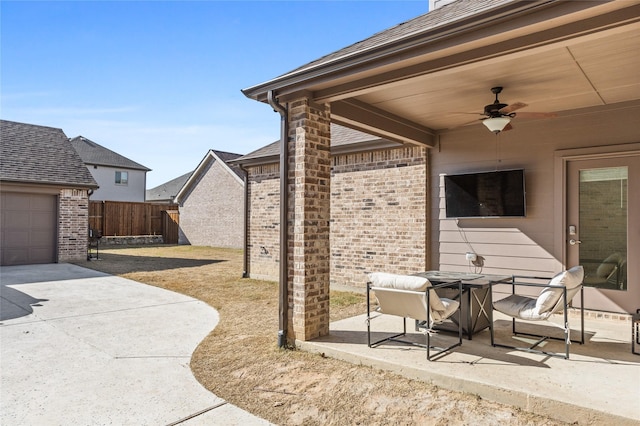 view of patio with a garage and ceiling fan