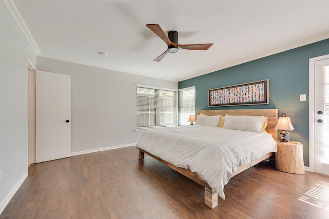 bedroom featuring dark wood-type flooring, ornamental molding, and ceiling fan