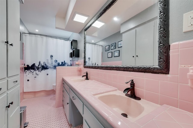 bathroom featuring walk in shower, vanity, toilet, and tile patterned flooring