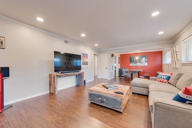 living room with crown molding and wood-type flooring