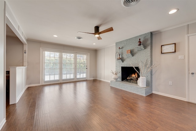 unfurnished living room with crown molding, a fireplace, ceiling fan, and hardwood / wood-style flooring