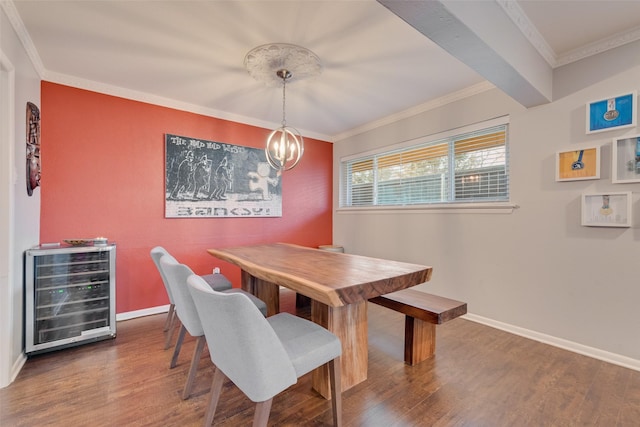 dining room with dark hardwood / wood-style floors, a chandelier, wine cooler, ornamental molding, and beamed ceiling