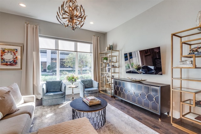 living room featuring dark hardwood / wood-style flooring and a chandelier