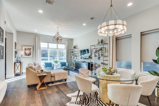 dining room with an inviting chandelier and dark wood-type flooring