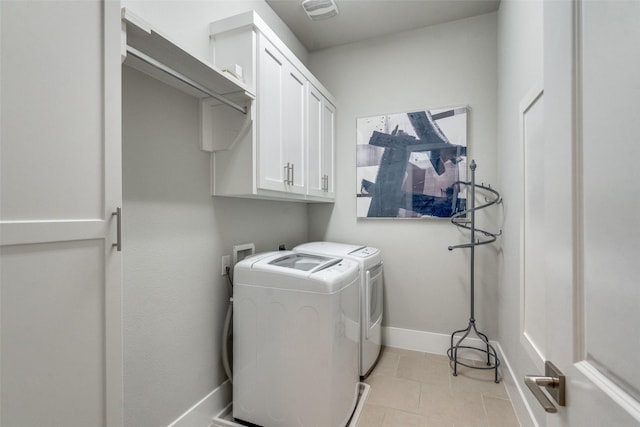 laundry room featuring cabinets and washer and clothes dryer