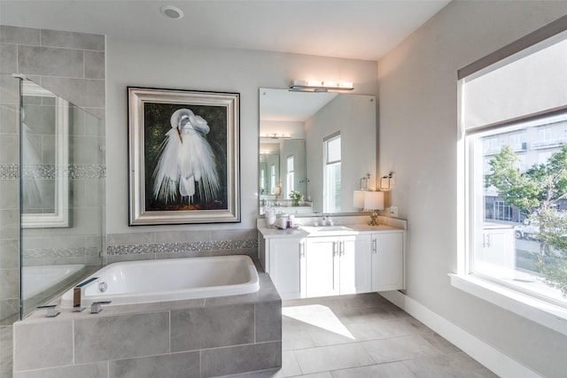 bathroom with vanity, plenty of natural light, tile patterned floors, and separate shower and tub