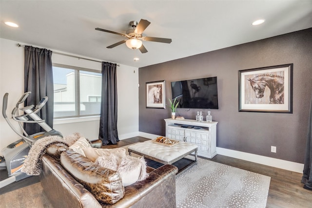 living room with ceiling fan and dark hardwood / wood-style flooring