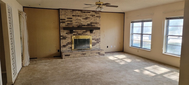 unfurnished living room featuring light colored carpet, a wealth of natural light, a textured ceiling, and a fireplace