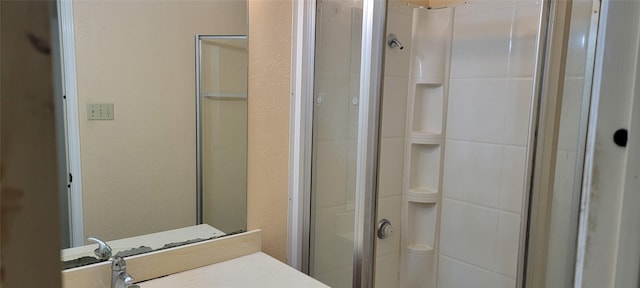 bathroom with an enclosed shower and vanity