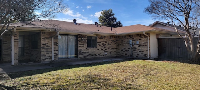 rear view of property featuring a lawn