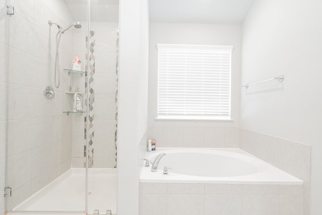 bathroom featuring shower with separate bathtub