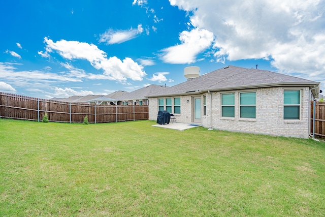 rear view of property with a patio and a lawn