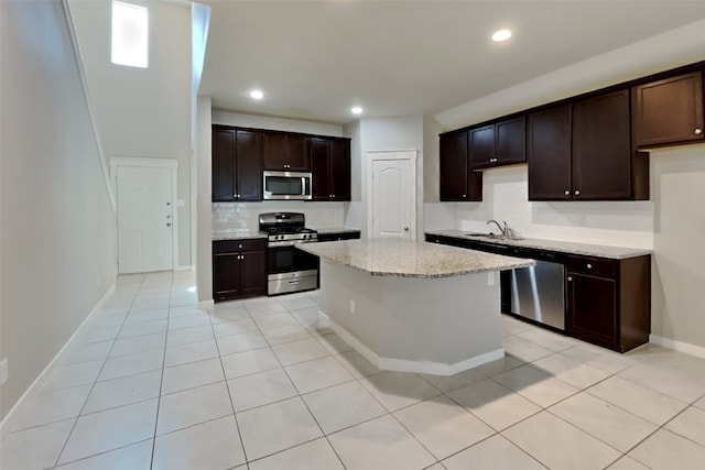 kitchen with dark brown cabinetry, sink, and appliances with stainless steel finishes