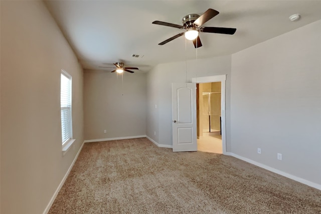 carpeted empty room featuring ceiling fan