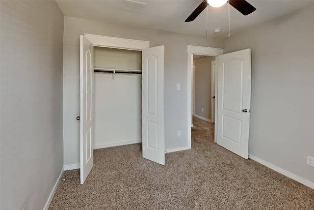 unfurnished bedroom with ceiling fan, a closet, and light carpet