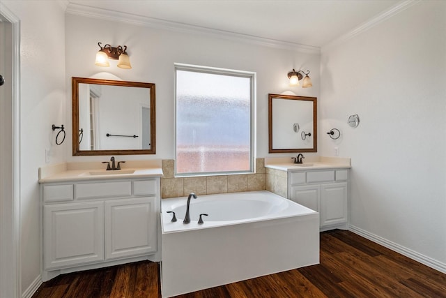 bathroom featuring vanity, a tub to relax in, wood-type flooring, and ornamental molding