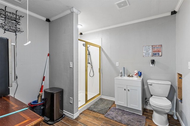 bathroom featuring vanity, ornamental molding, toilet, and walk in shower