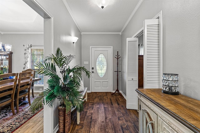 entrance foyer featuring dark hardwood / wood-style flooring, crown molding, and a textured ceiling