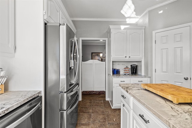 kitchen featuring ornamental molding, stainless steel appliances, and white cabinets