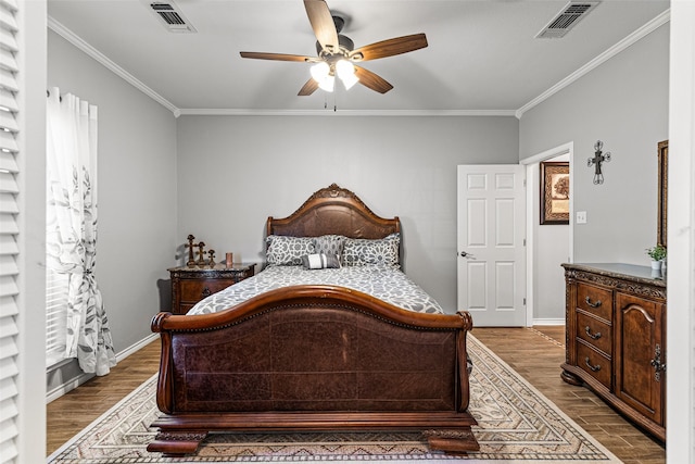 bedroom with multiple windows, crown molding, wood-type flooring, and ceiling fan