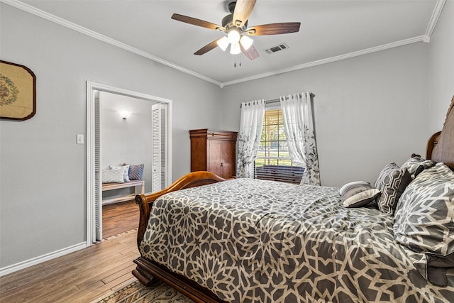 bedroom featuring hardwood / wood-style flooring, ceiling fan, and ornamental molding