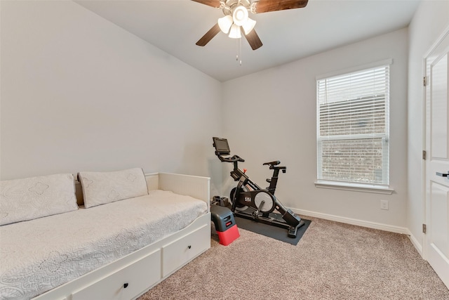 workout room featuring ceiling fan and light colored carpet