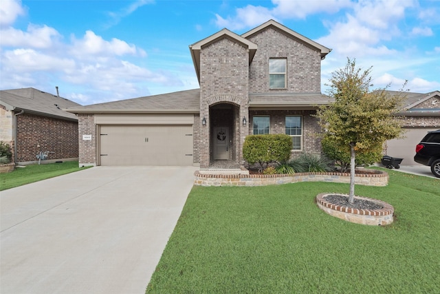 view of front of property featuring a garage and a front yard