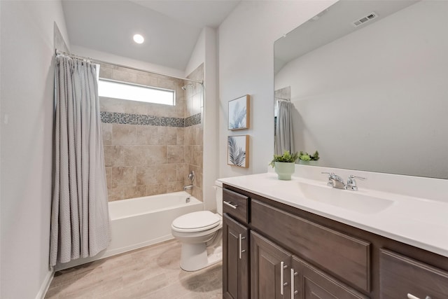 full bathroom featuring vanity, hardwood / wood-style flooring, shower / bath combination with curtain, and toilet