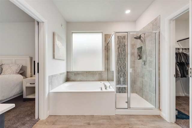 bathroom with hardwood / wood-style floors and plus walk in shower