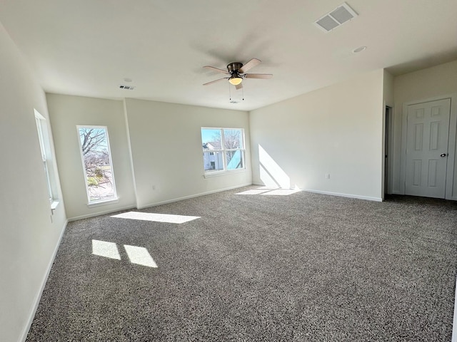 carpeted empty room featuring ceiling fan