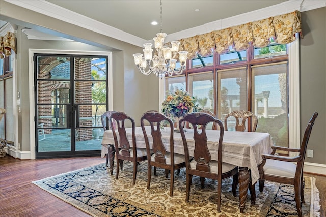 dining space with crown molding, dark hardwood / wood-style floors, and a notable chandelier