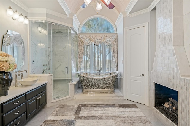 bathroom featuring lofted ceiling, vanity, ornamental molding, and independent shower and bath