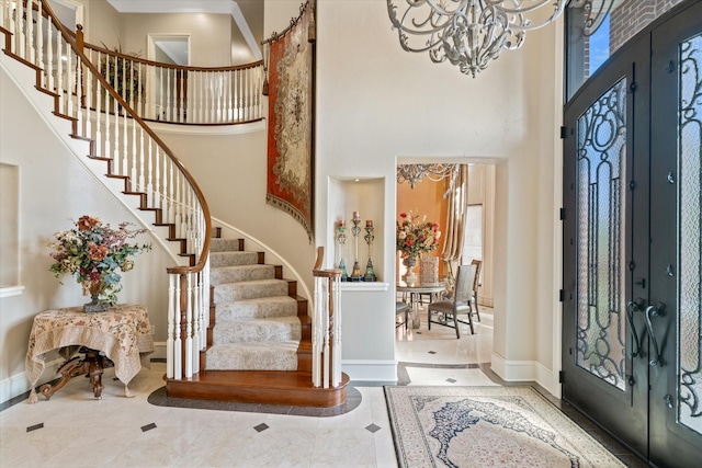 foyer entrance featuring a high ceiling and a chandelier