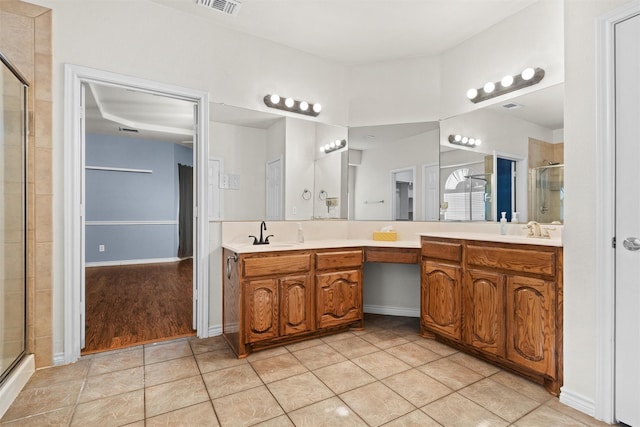 bathroom featuring vanity, tile patterned floors, and walk in shower