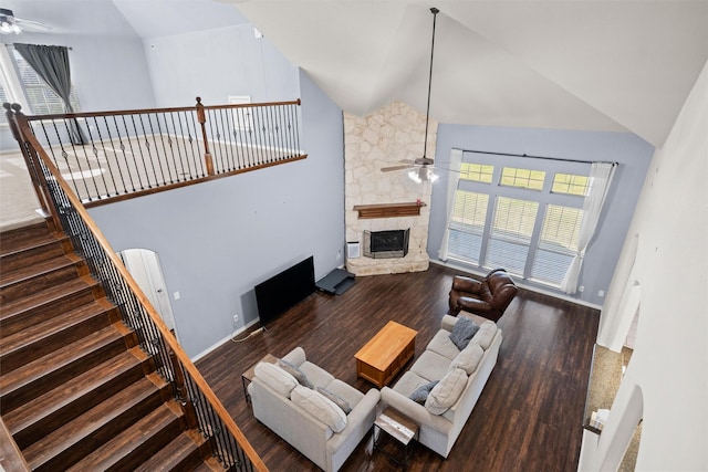 living room with ceiling fan, high vaulted ceiling, dark hardwood / wood-style floors, and a fireplace