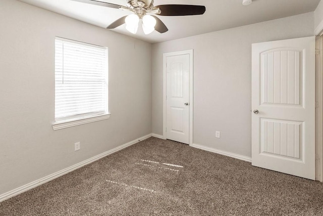 unfurnished bedroom with carpet flooring, baseboards, and ceiling fan