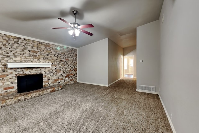 unfurnished living room with lofted ceiling, a fireplace, ceiling fan, and carpet flooring