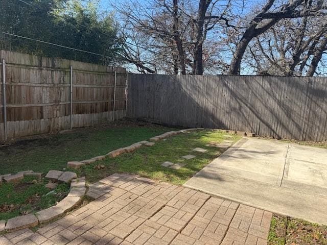 fenced backyard featuring a patio