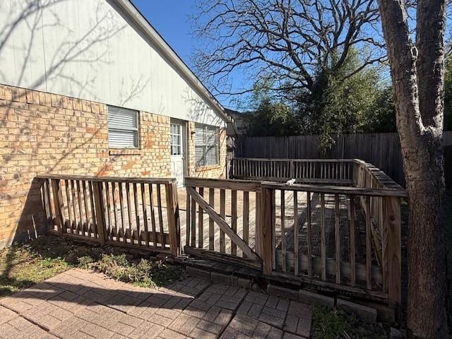 wooden terrace with a patio area