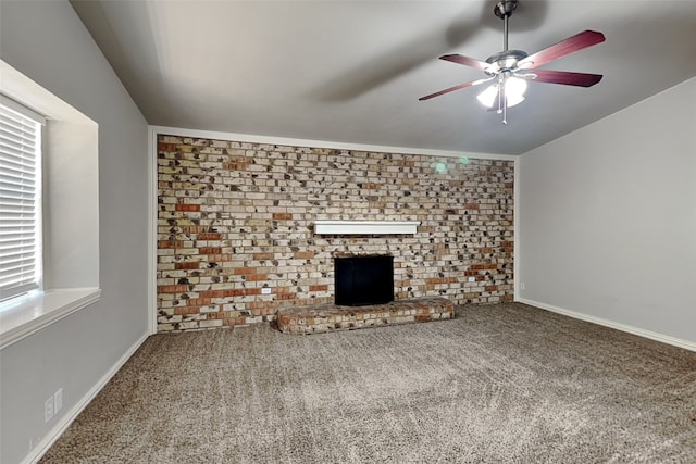 unfurnished living room featuring a brick fireplace, carpet floors, ceiling fan, and plenty of natural light