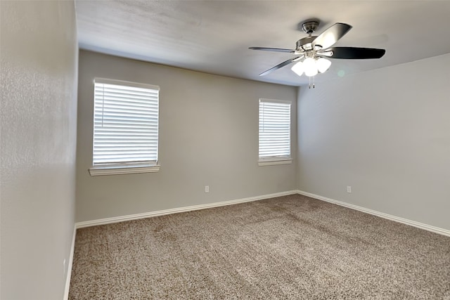 carpeted spare room with ceiling fan