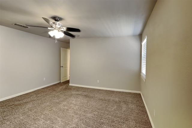 carpeted spare room with ceiling fan