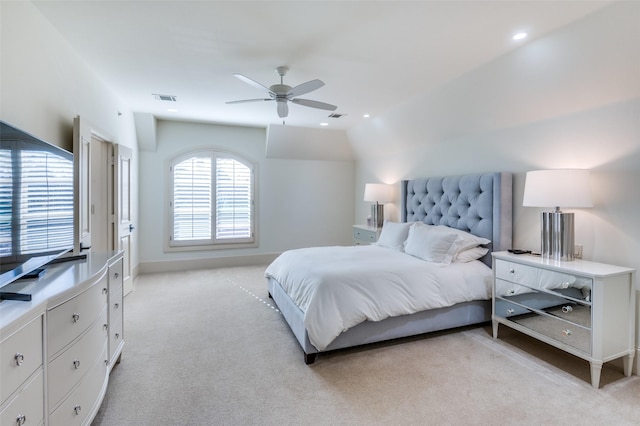 carpeted bedroom featuring lofted ceiling and ceiling fan