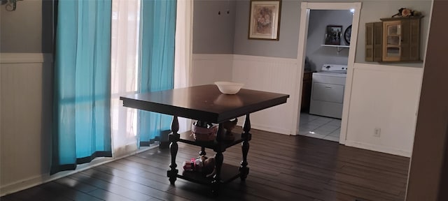 dining room with dark hardwood / wood-style floors and washer / dryer