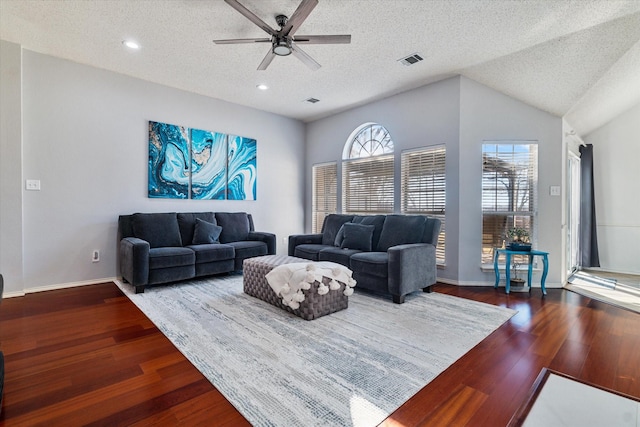 living area featuring a textured ceiling, recessed lighting, wood finished floors, visible vents, and baseboards